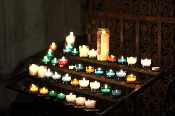 Prayer candles in a cathedral.  Photo by Evan Schneider.